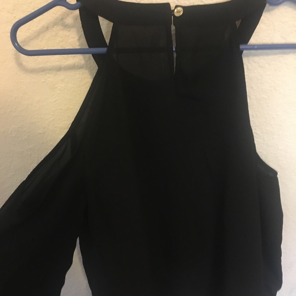 Black blouse with exposed shoulder long sleeve.